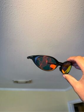 Black Oval Sunglasses with Red-Orange Mirrored Lenses Oakleys